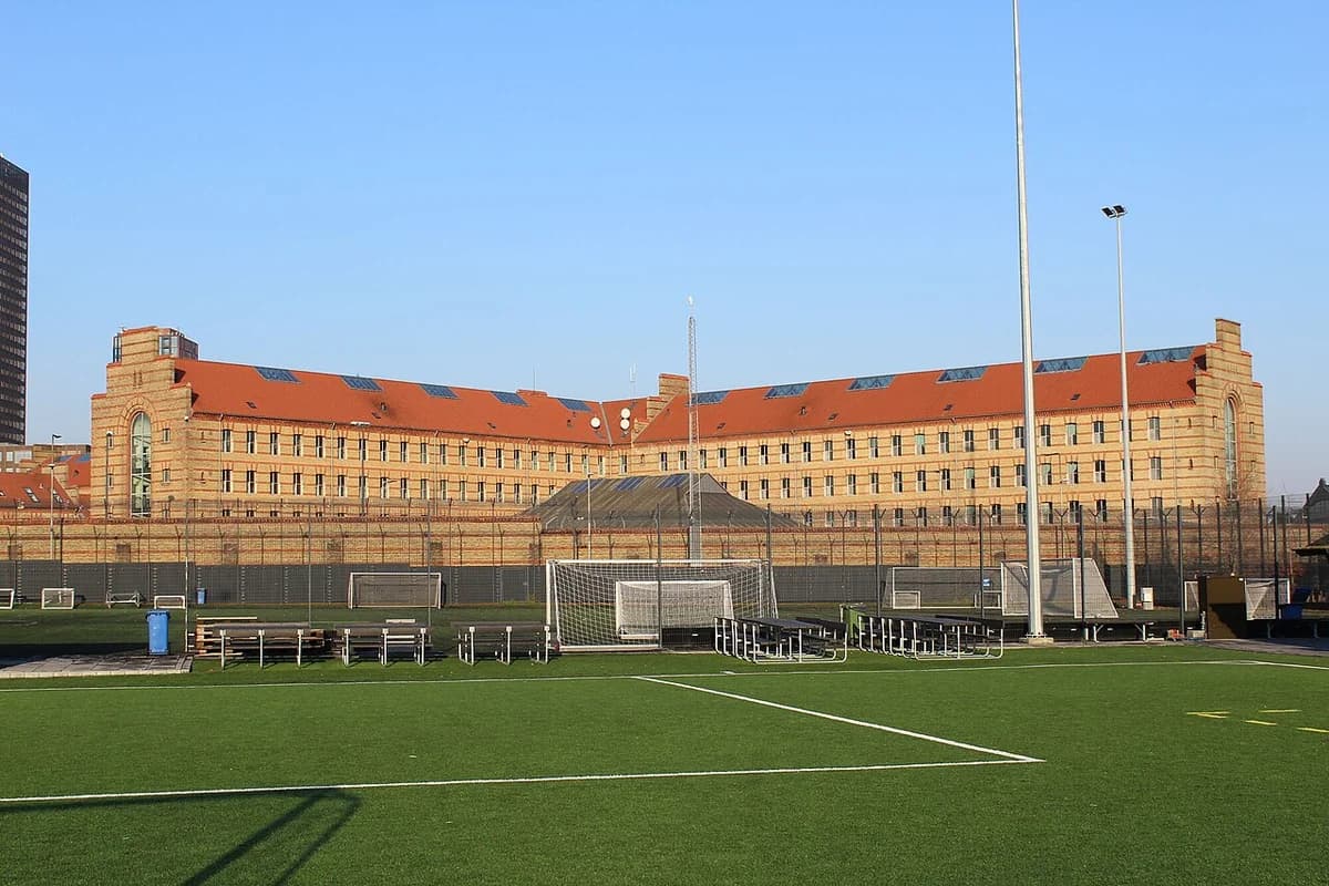 Vestre Prison behind a fenced sports field in Copenhagen.
