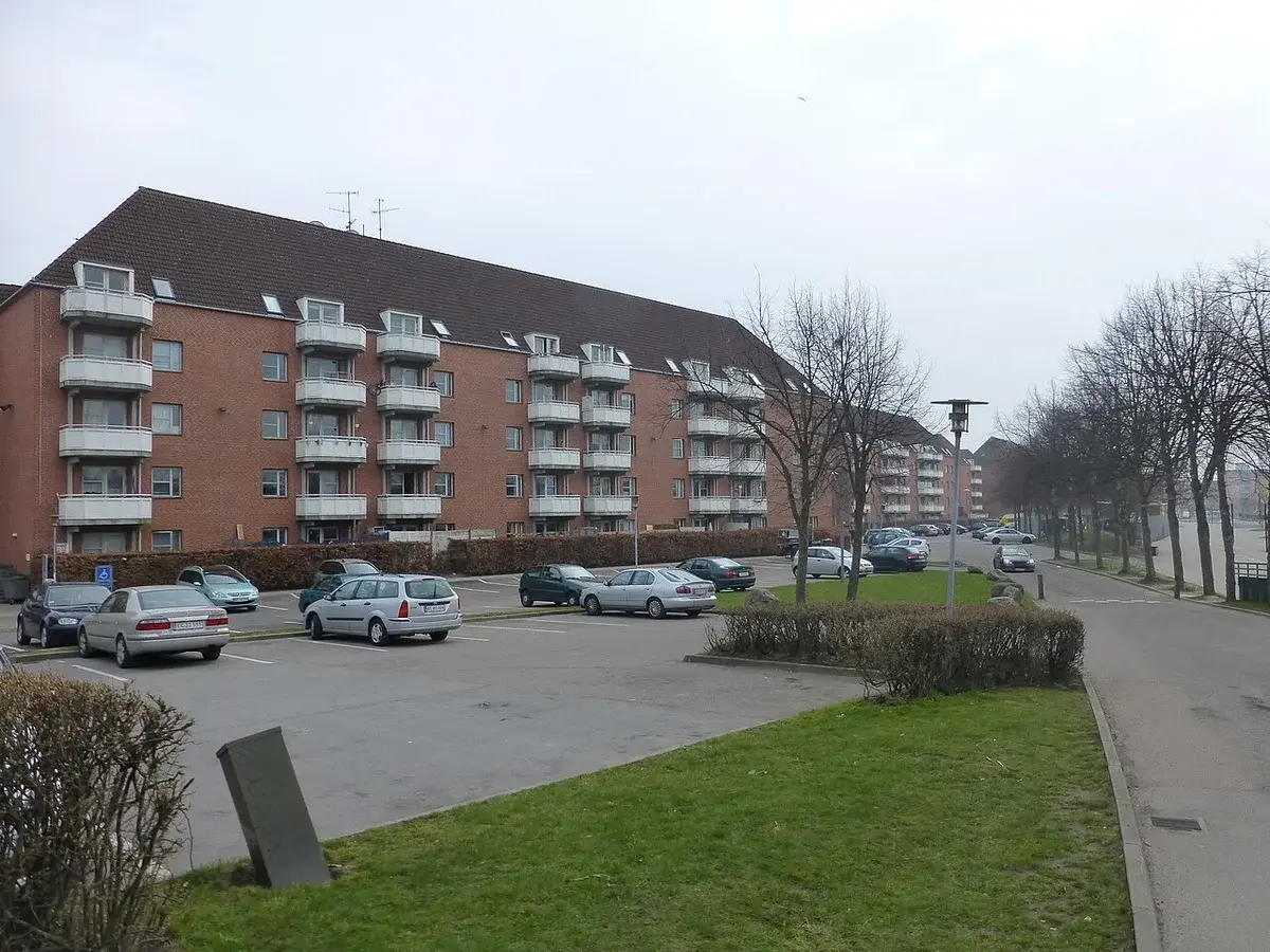 Apartment buildings and parked cars in a Danish residential area.