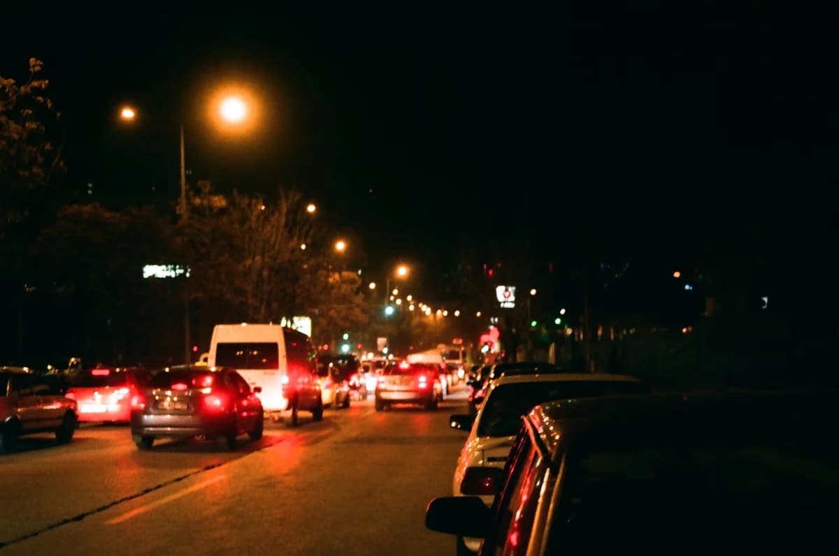busy street with cars and streetlights at night
