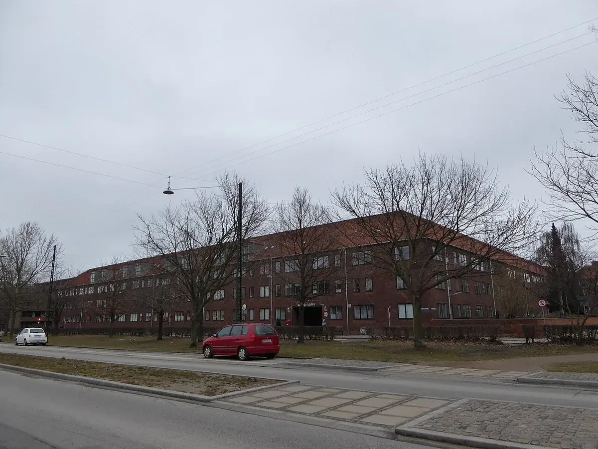 Red-brick nursing home building on a quiet Copenhagen street.