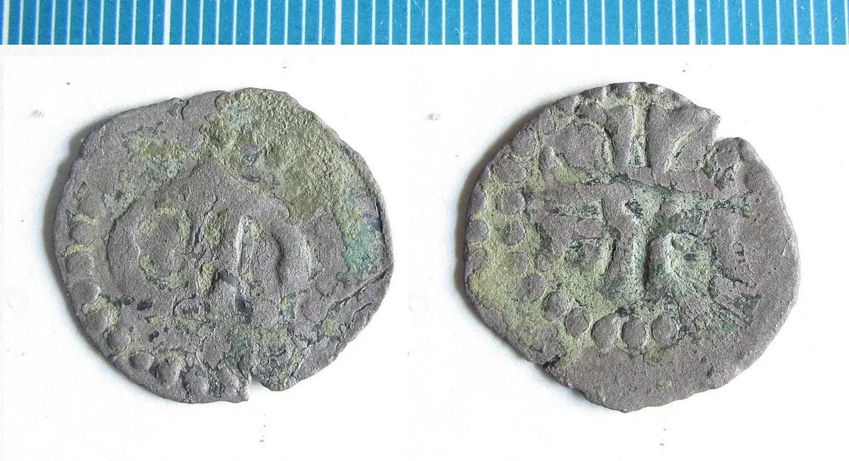 Two sides of an old Danish silver coin photographed on a white background.