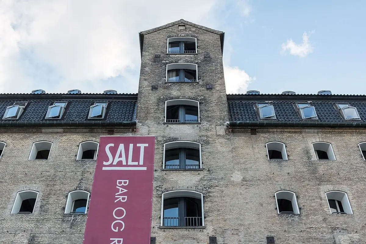 Historic brick hotel building in Copenhagen with a large SALT sign.