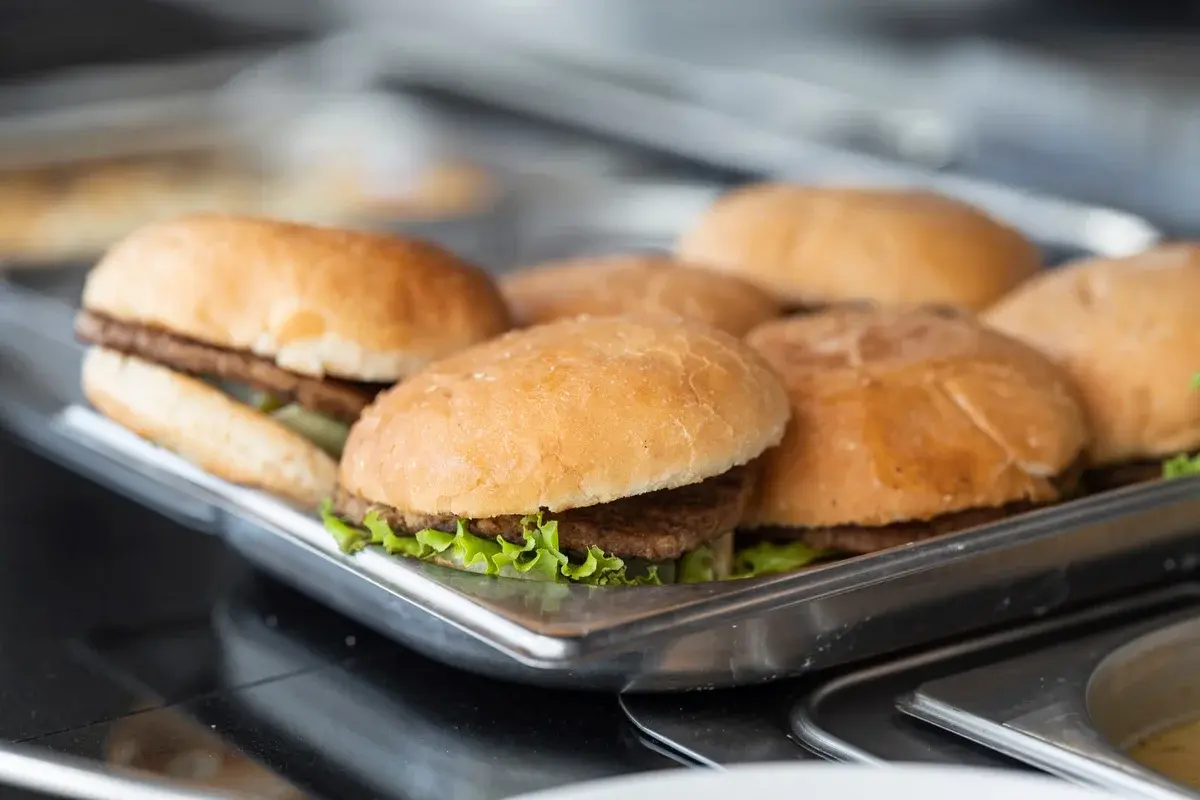 Close-up of burgers on a stainless steel tray