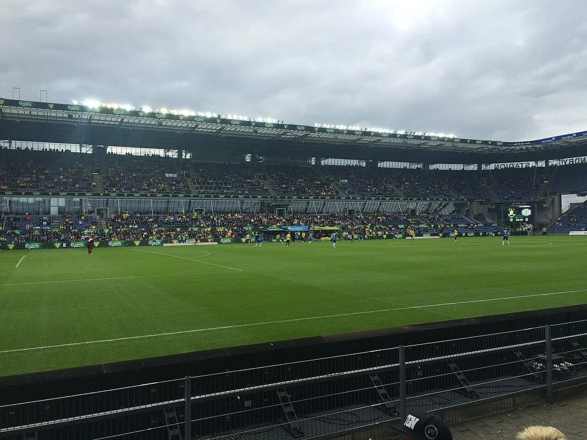 Football match inside Brøndby Stadium with crowd and players