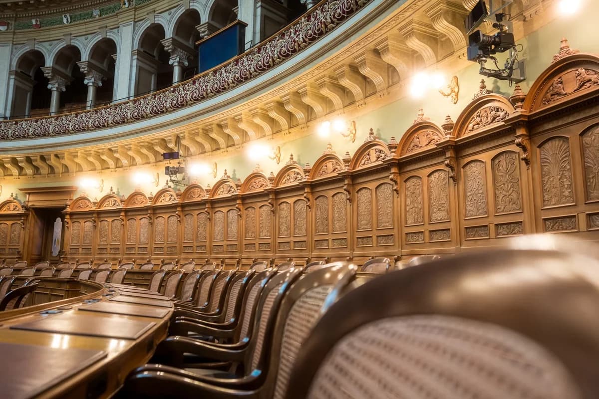 Interior of the Swiss Federal Assembly chamber with ornate wood paneling and seating