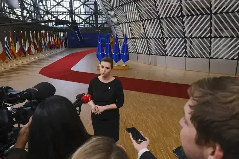 Mette Frederiksen speaking to press at European Council with flags behind