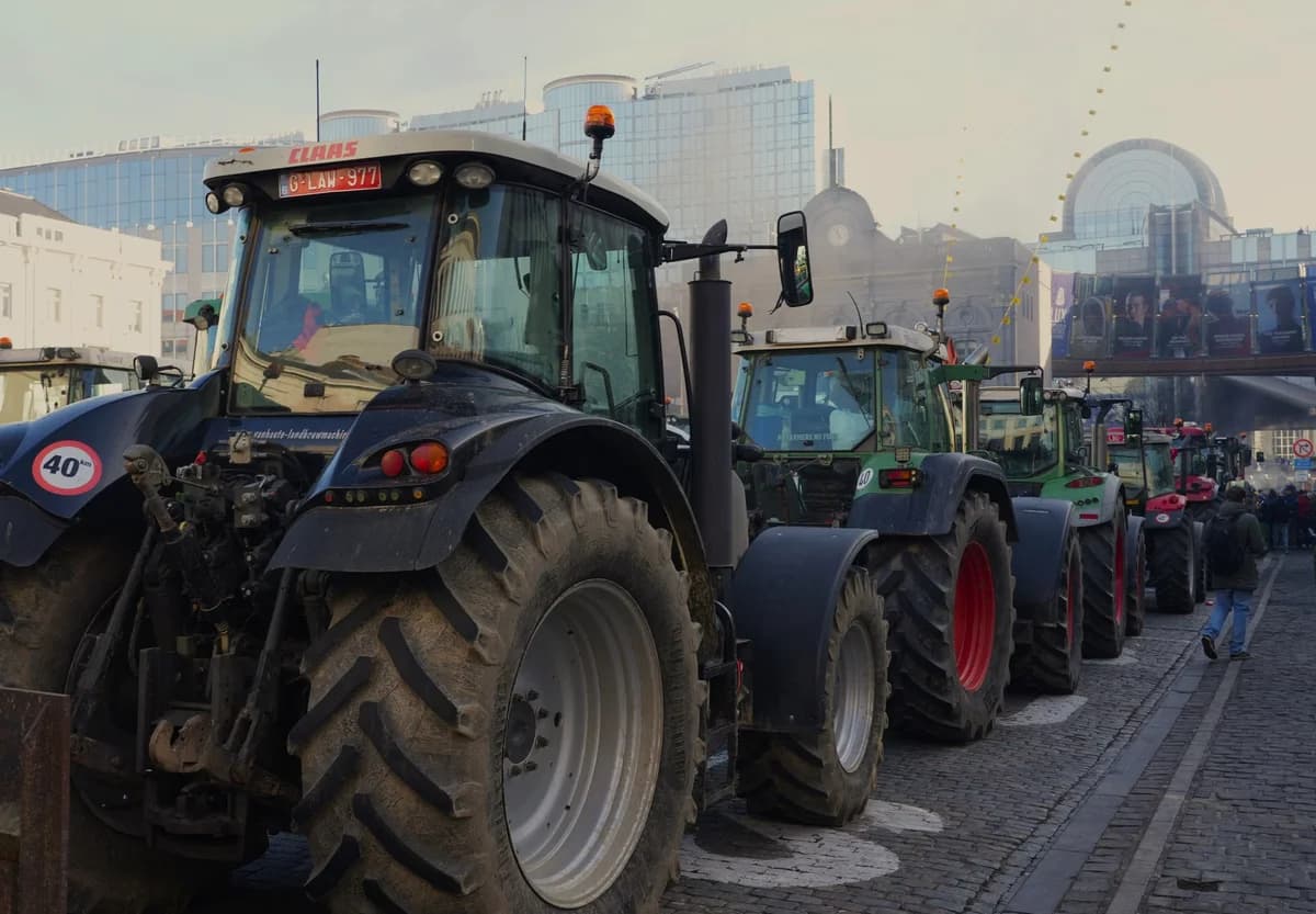 Row of tractors parked on city street during protest