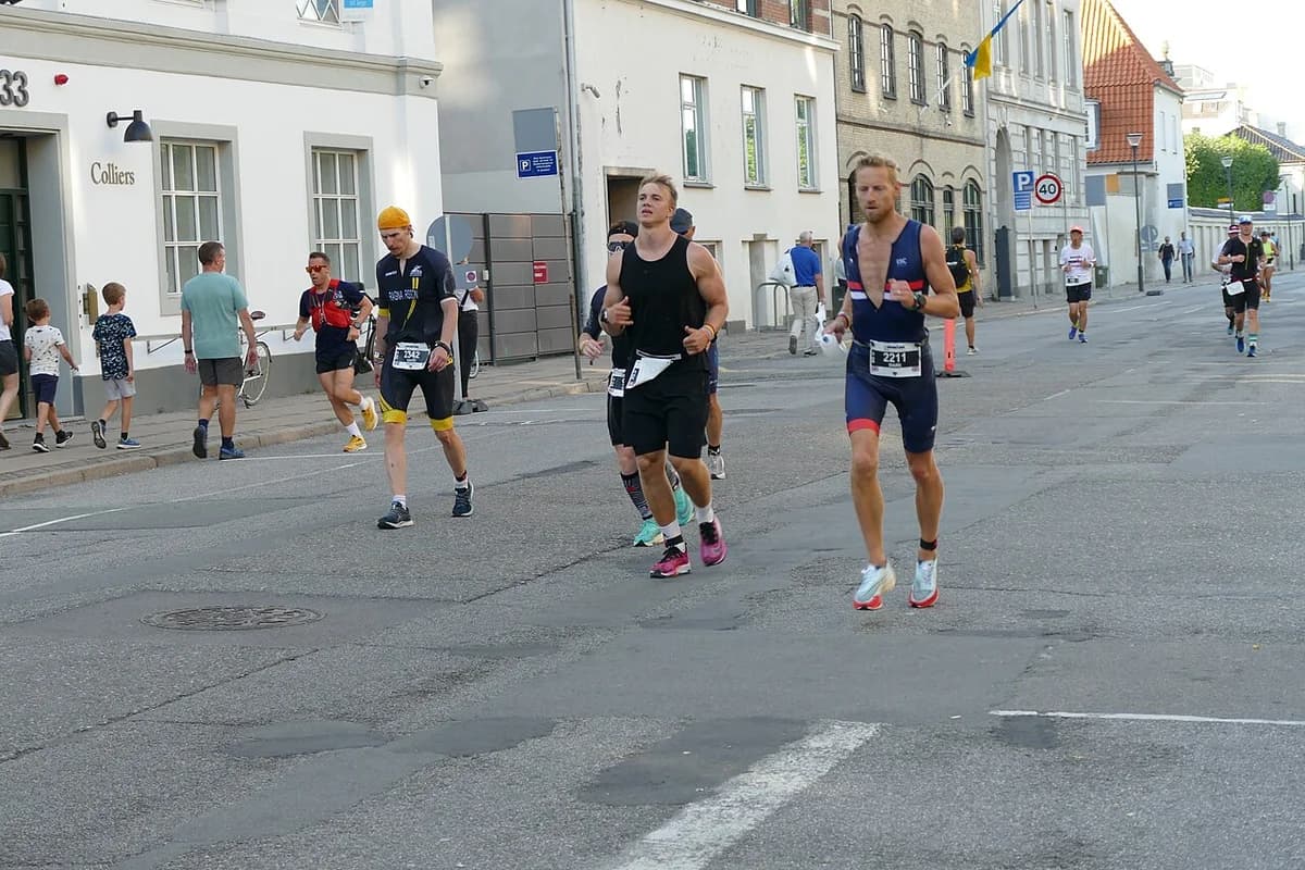 Athletes running on a city street during Ironman Copenhagen 2022 event