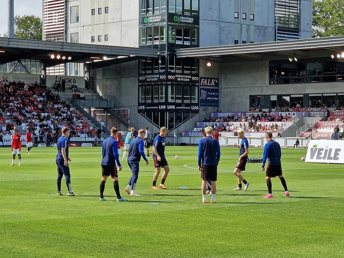 Soccer players warming up on field at stadium