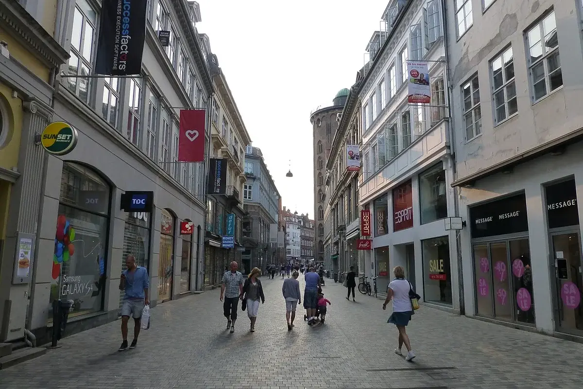Pedestrians walking along Strøget shopping street in Copenhagen.