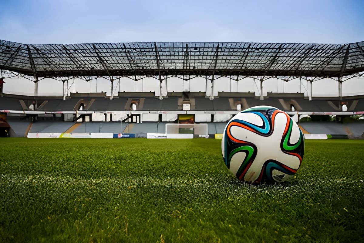 Colorful soccer ball on grass field in stadium