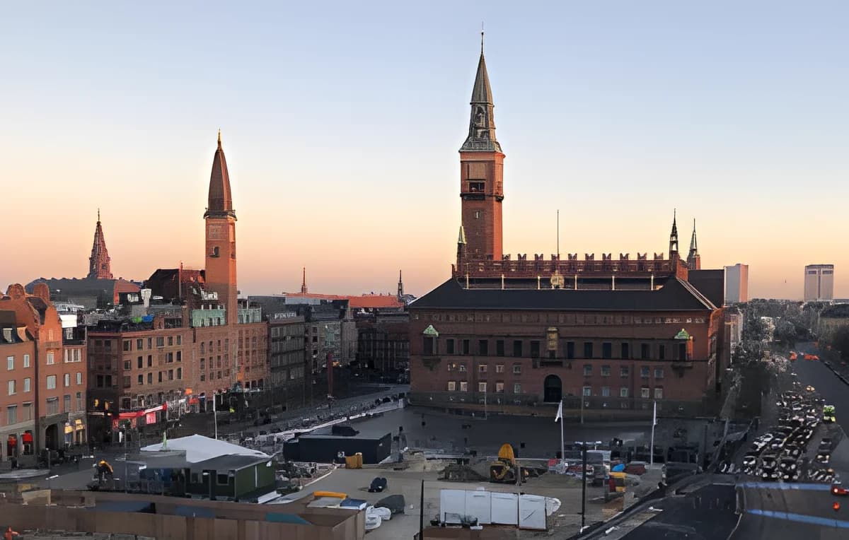 Copenhagen City Hall at sunset with city buildings and construction site