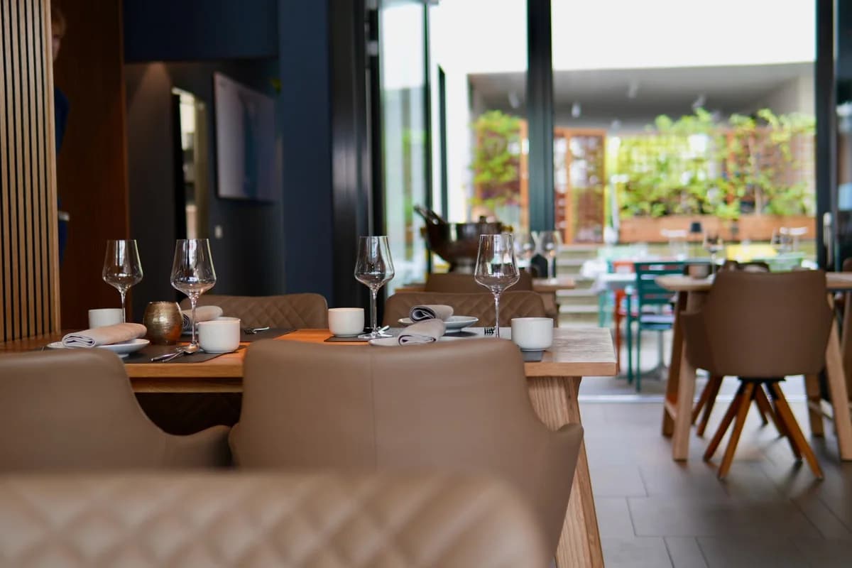 A stylish restaurant dining area with set tables and chairs.