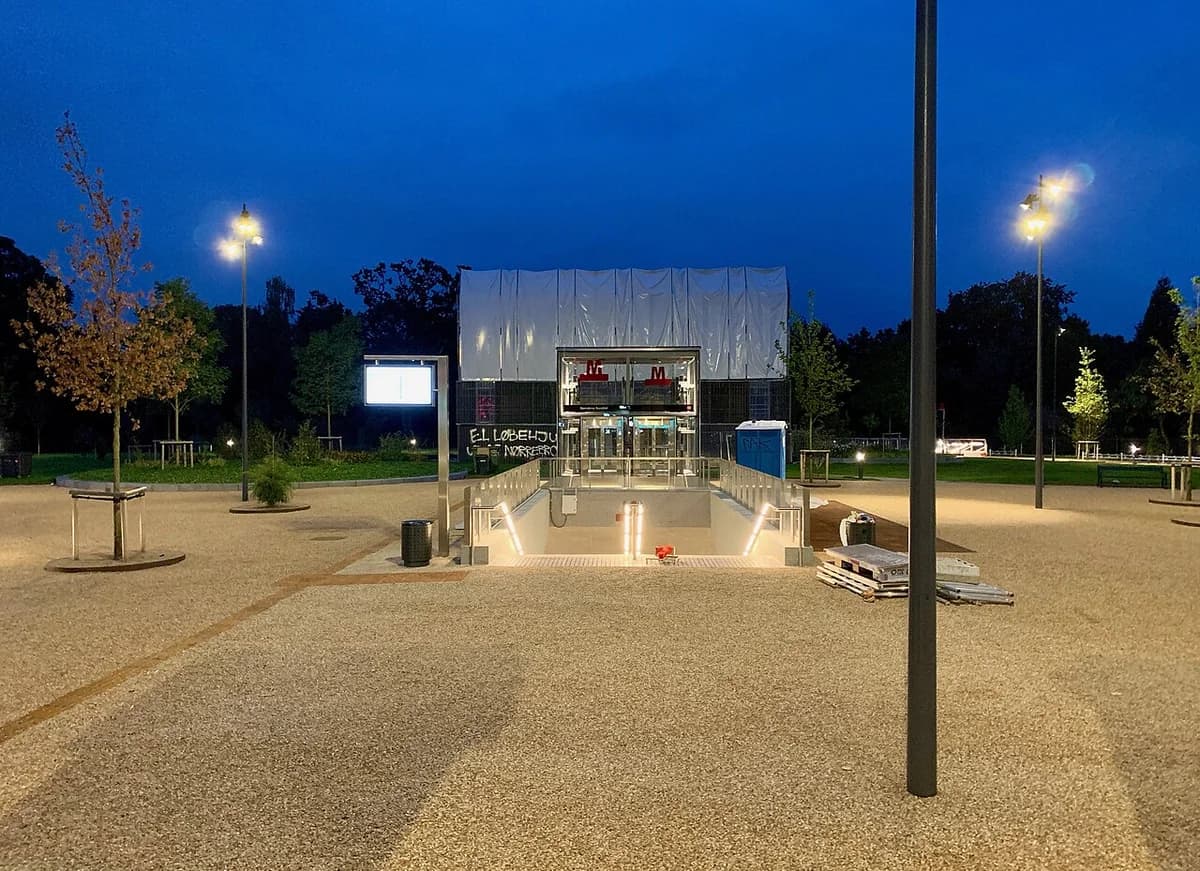 Night view of the Nørrebros Runddel metro station entrance in Copenhagen.