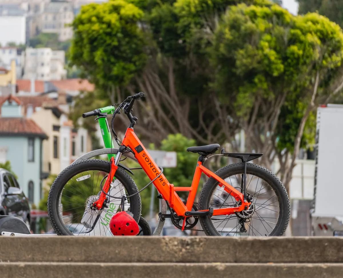 Two electric bikes parked near urban steps