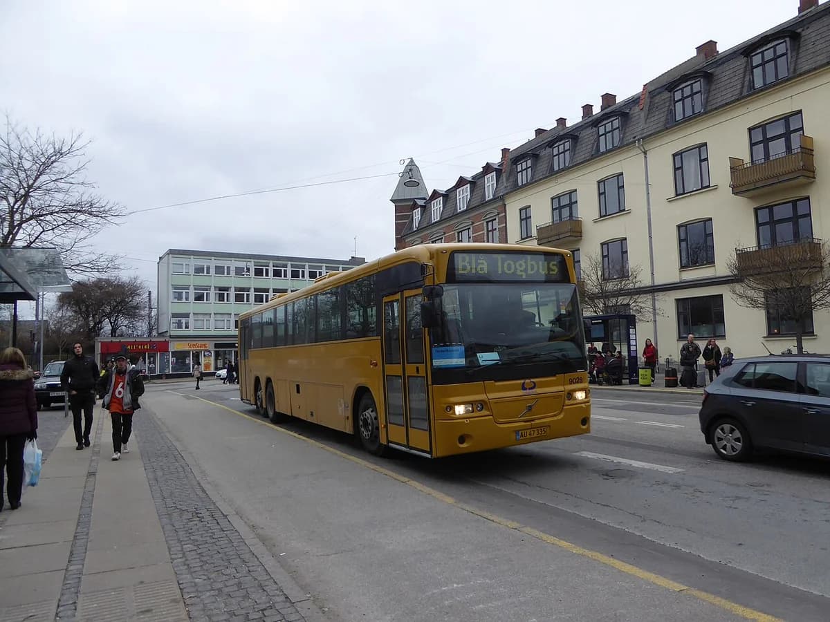 Yellow replacement bus on a street near Vanløse Station in Copenhagen.